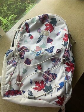The North Face White Backpack with Red & Blue Butterfly Leaf Print